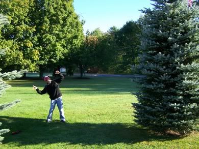 Tim tosses one end of the rope in a tree