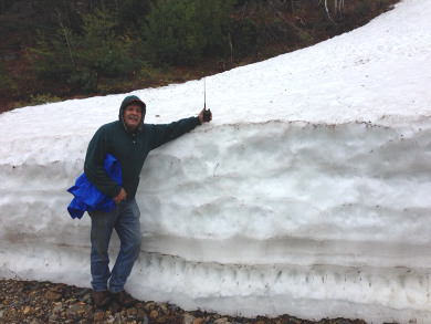 Charlie poses by a bank of snow